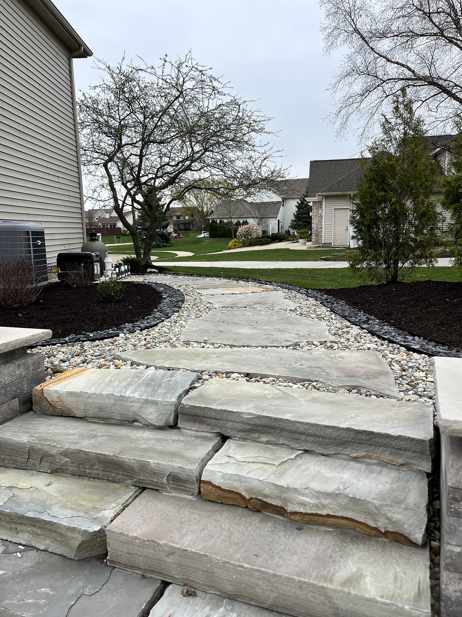 Natural-stone steps, walkway, and finished planting beds